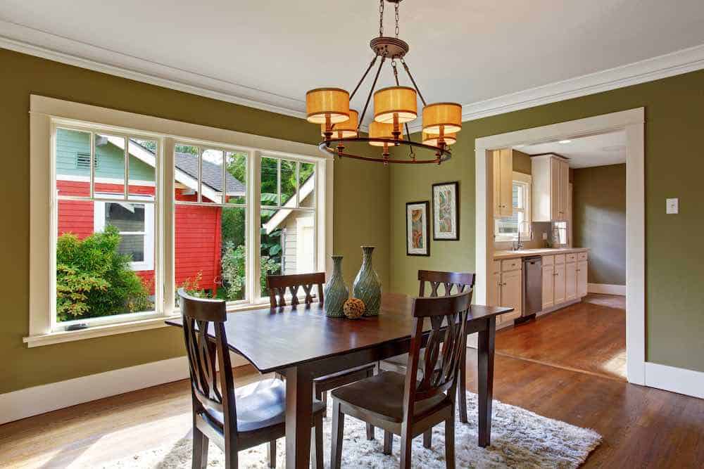 Dining Room With Green Walls and Painted Trim