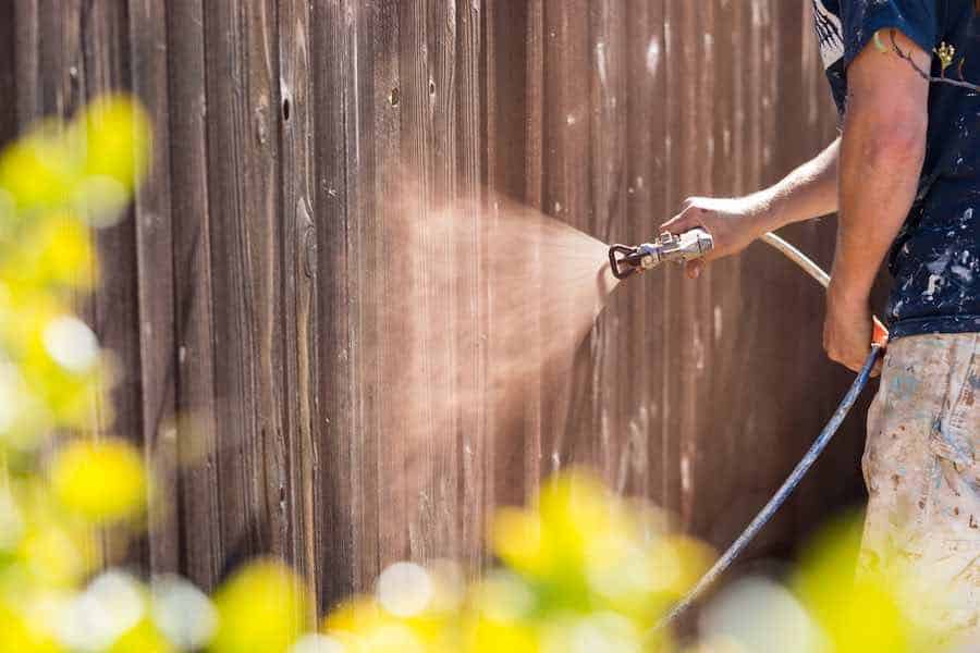 Spray painting a fence