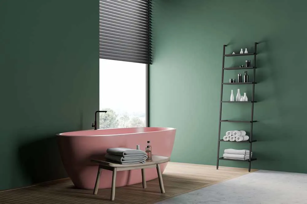 22 Inspiring Bathroom Paint Colors 17 A sophisticated bathroom with lots of natural light, dark green painted walls, and pink tub.