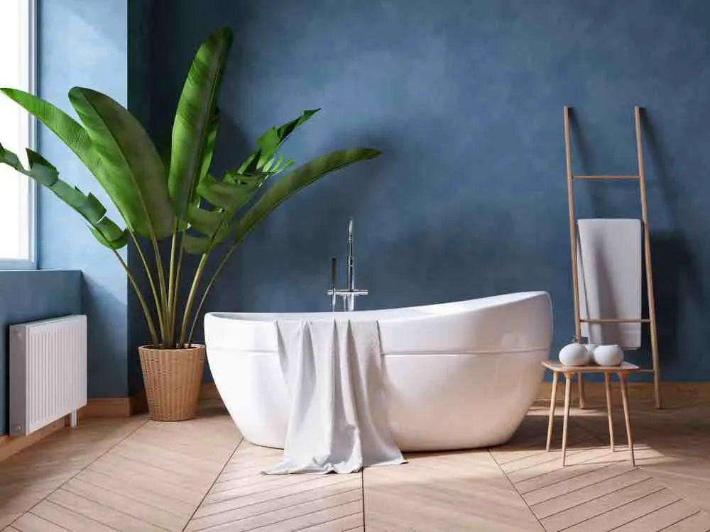 22 Inspiring Bathroom Paint Colors 12 A white stand-alone tub with a potted plant and dark blue faux-finish walls.