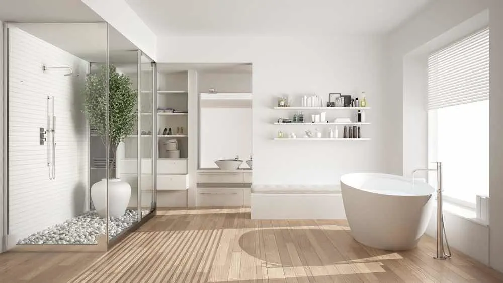 22 Inspiring Bathroom Paint Colors 22 A super-white minimalist Scandinavian bathroom with natural wood floors, painted walls, and a potted tree in the shower.