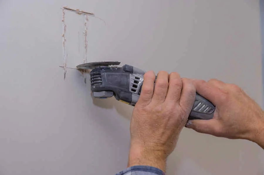 How to Remove Drywall Quickly, Easily, and Mess Free 3 removing a small section of drywall for an electrical outlet
