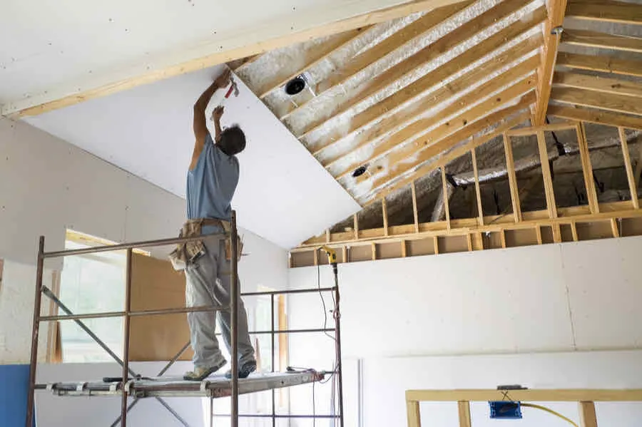 Drywall Thickness Guide: What to Use and Where 3 man installing drywall on the ceiling