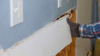 removing a piece of drywall from a wall