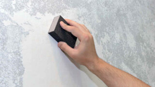 working sanding drywall mud
