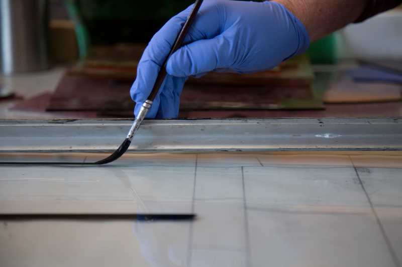 Painting glass with a soft-bristled brush