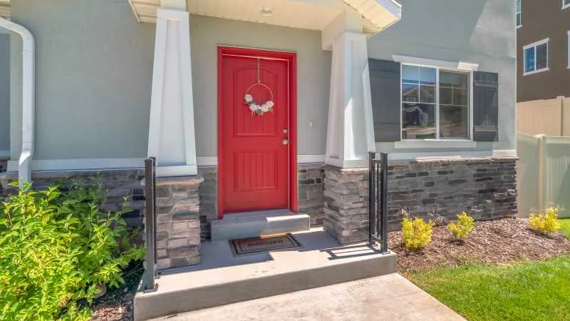 12 Amazing Gray Exterior House Paint Ideas 4 A gray house with complementary red door and white columns and trim