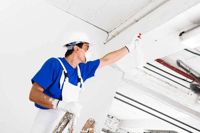 How To Remove Popcorn Ceiling Texture - The Best Method 6 spraying a ceiling with water to prep for removing popcorn ceiling texture