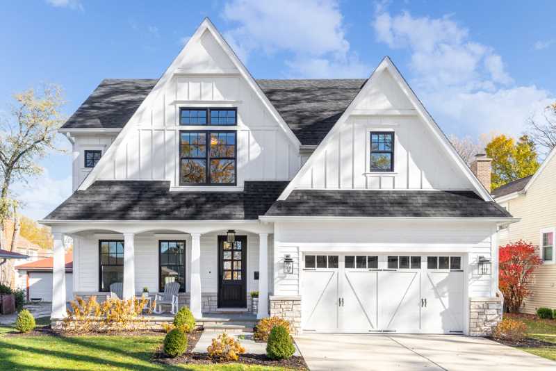 A bright white exterior accented with a dark Benjamin Moore exterior paint color on the front door and trim