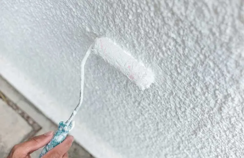 The 17 Best Exterior White Paint Shades for Your Home 2 Painting the exterior of a house with one of the best exterior white paint shades