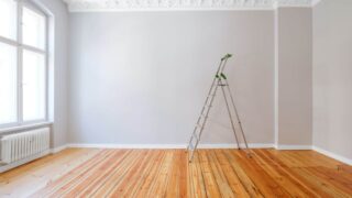 A room painted in a light neutral with white trim and ceiling.