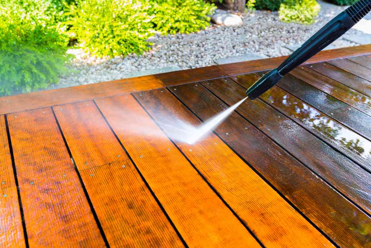 Using the best electric pressure washer to clean grime off a deck