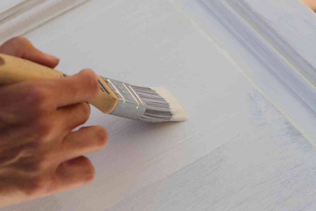 Using the best paint brush for kitchen cabinets to paint cabients white