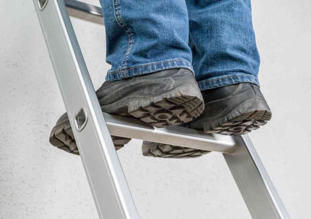 The Best Ladder For Painting Stairs The Choice Is Obvious DIY   Man Standing On A Ladder 1024x721 