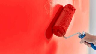 Painting a red wall showing how to fix uneven paint sheen