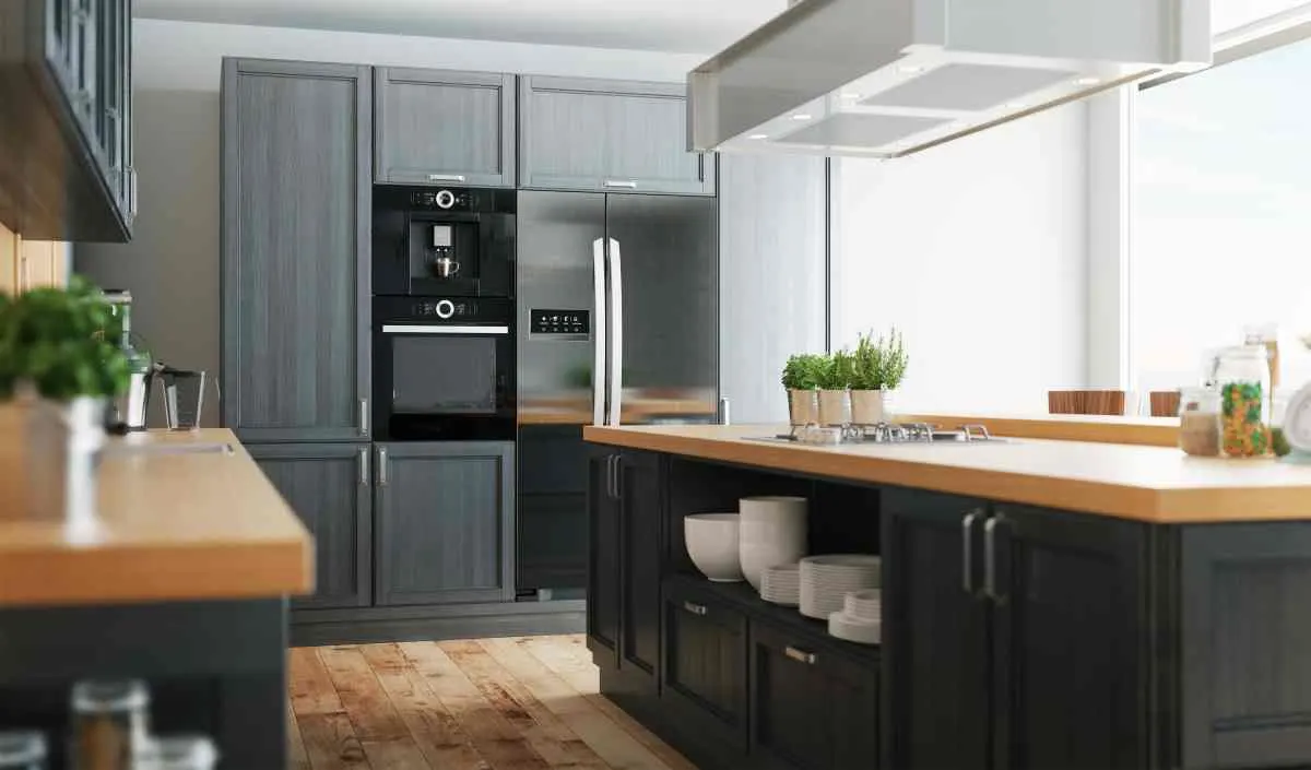 Gray cabinets with wood countertops topped with plants and accessories