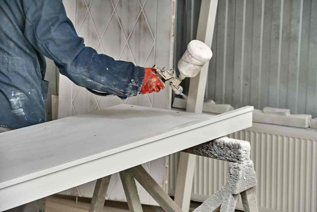 Professional painter spray painting kitchen cabinets