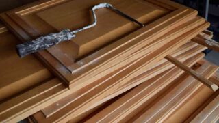 Kitchen cabinet doors removed in order to paint them with the best roller for painting cabinets