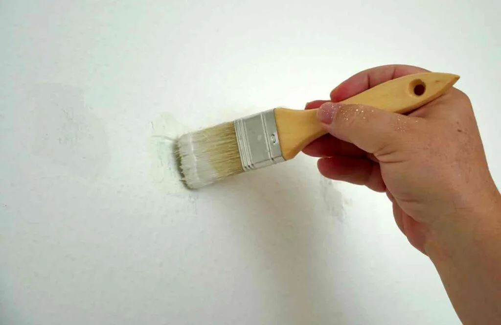How to Remove Drywall Anchors Without Damaging Your Walls 5 Using a paintbrush to touch up a wall after repairing it