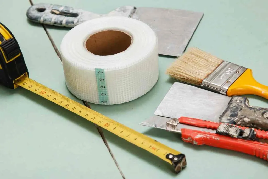 The Essential Drywall Repair Kit: 14 Tools and Materials You Need for Quick Fixes 1 Measuring tape, drywall tape, and other tools needed for a drywall repair kit