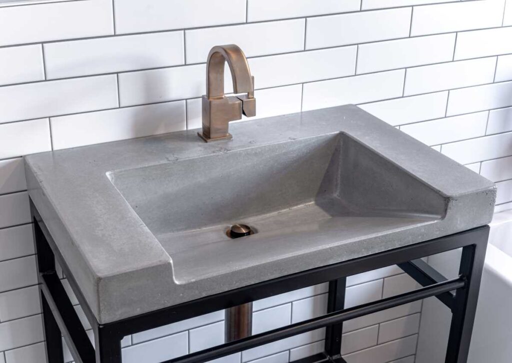A DIY Guide to Spray Painting Bathroom Fixtures 1 Bathroom sink with bronze faucet and black metal legs. Spray painting bathroom fixtures