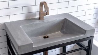 Bathroom sink with bronze faucet and black metal legs. Spray painting bathroom fixtures